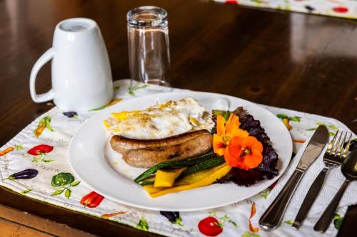 a white plate of food on a table at Upper Humber Settlement a FarmStay B&B in Cormack