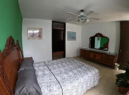 a bedroom with a bed and a ceiling fan at Casa San Antonio in Aguascalientes