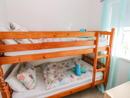 two bunk beds in a small room with at Driftwood House in Saundersfoot