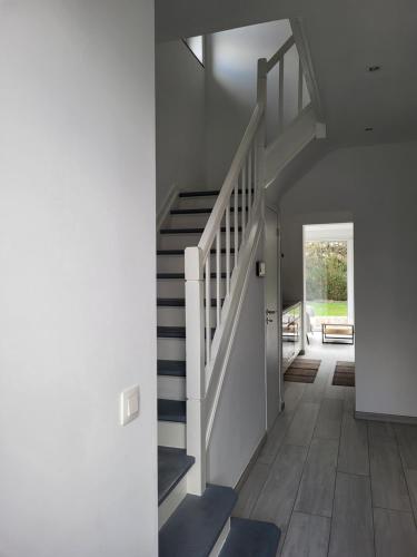 a staircase in a house with a white stair case at Villa Bed & Garden in Brussels