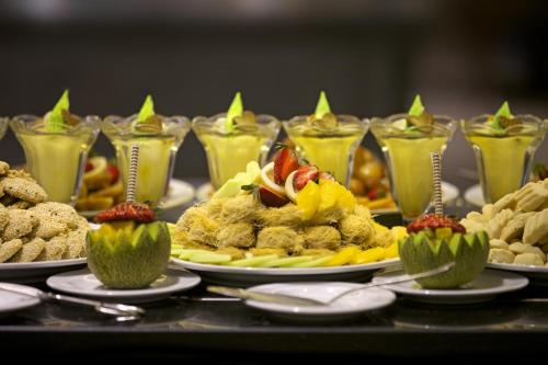 a buffet filled with plates of food and desserts at Gafy Resort Aqua Park in Sharm El Sheikh
