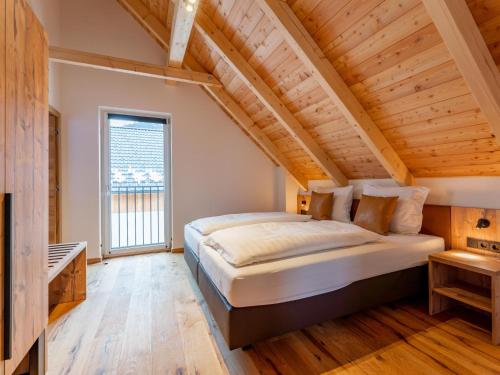 a bedroom with a large bed in a attic at Mountain Chalet Alpinchique 2 in Sankt Lorenzen ob Murau