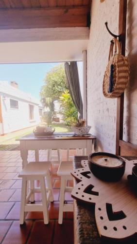 a kitchen with a table and stools and a table at TU CASA Rent House in Esperanza