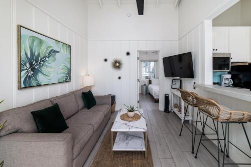 a living room with a couch and a kitchen at Pacific Villas in Oceanside