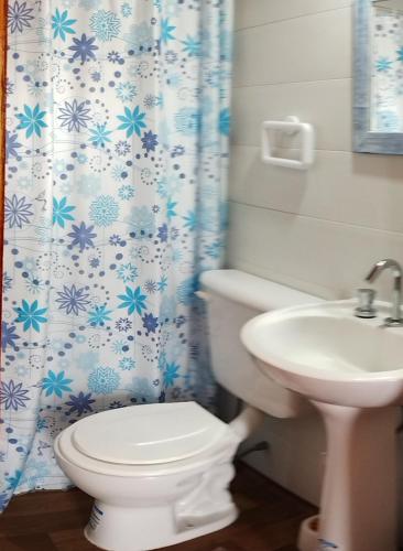 a bathroom with a toilet and a sink at La Beatriz in San José