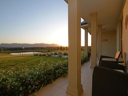 a porch of a house with a view of a field at Silver Springs 6br Luxury Homestead in Rothbury