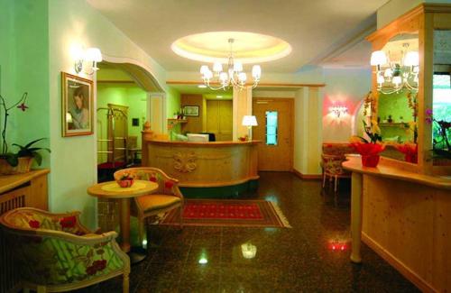 a living room with a large room with green walls at Hotel Florida in Levico Terme