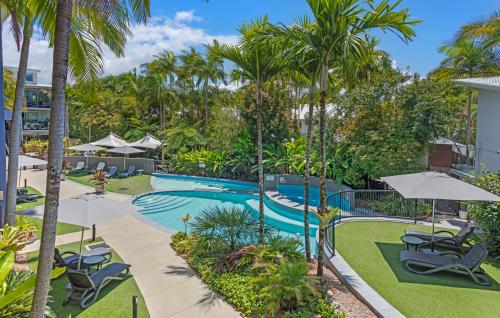 an image of a swimming pool with palm trees at Verano Resort Noosa in Noosaville