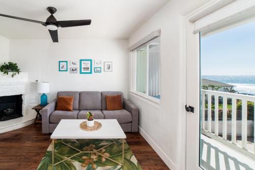 a living room with a couch and a table at Pacific Villas in Oceanside