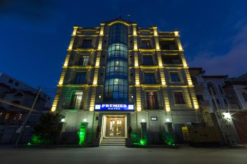 a tall building with lights on it at night at Premier Hotel in Baku