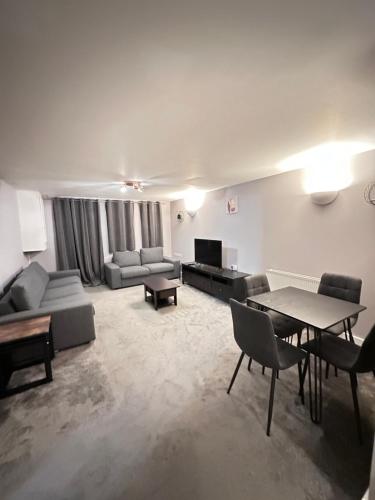 a large living room with couches and a table at Pier Road in London