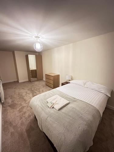 a bedroom with a bed with two towels on it at Pier Road in London