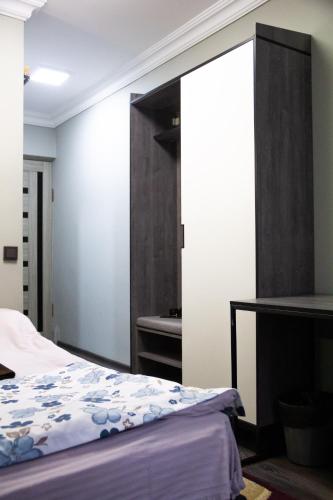 a bedroom with a bed and a mirror at Hotel Tahar in Almaty