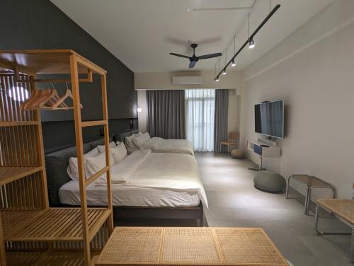a bedroom with a bunk bed and a flat screen tv at Kun living in Taitung City