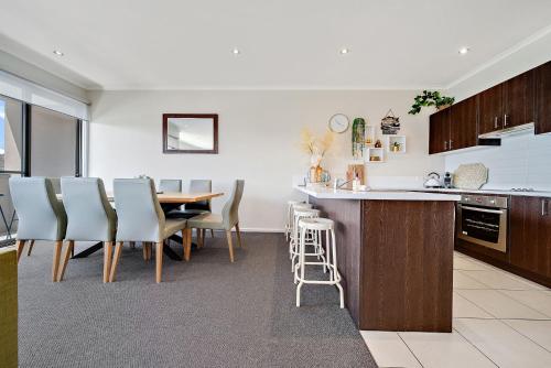 a kitchen and dining room with a table and chairs at Jasper 4 - 3BR Apartment l Central Location l Lake Views l WiFi l Air-Con in Jindabyne