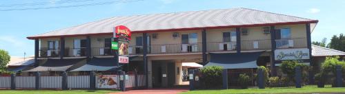 a building with a sign in front of it at Spanish Lace Motor Inn in Townsville