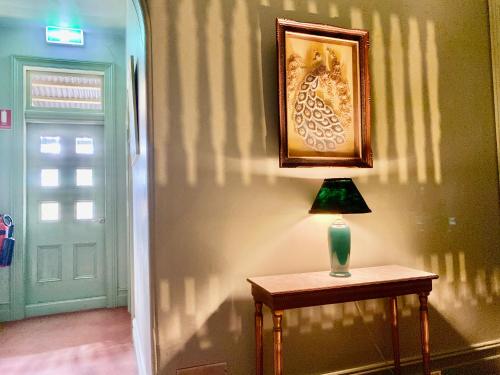 a lamp sitting on a table next to a door at Leura House in Leura