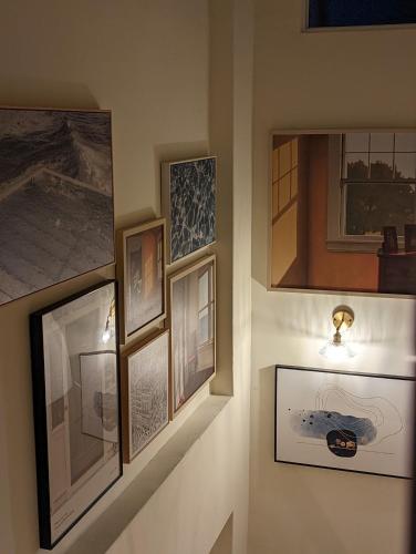 a group of framed pictures on a wall at Kun living in Taitung City