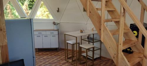 a kitchen with a staircase in a tiny house at Domotel Aysen in Puerto Aisén