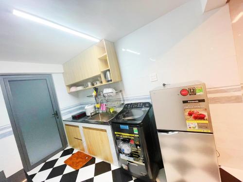 a small kitchen with a sink and a refrigerator at Can Tho Home & Apartment 3 in Can Tho