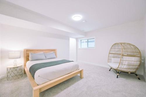 a bedroom with a bed and a chair at Oasis Getaway, Mins to Lake, King Bed, Dbl Garage in Invermere