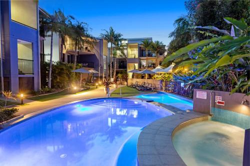 a swimming pool in a hotel at night at Verano Resort Noosa in Noosaville