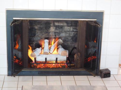 a fireplace with fire in it with food in it at Casa al Mare Beachfront Retreat King Bed Near Yale in East Haven