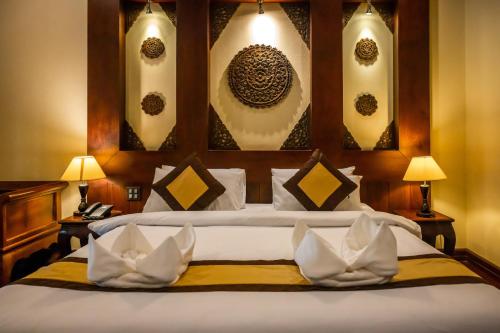Ένα ή περισσότερα κρεβάτια σε δωμάτιο στο Sada Hotel