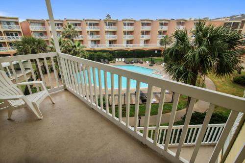 a balcony of a hotel with a swimming pool at Victorian 9203-Ocean Oasis in Galveston