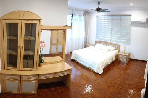a bedroom with a bed and a dresser at Cosy and family friendly house in Sungai Petani