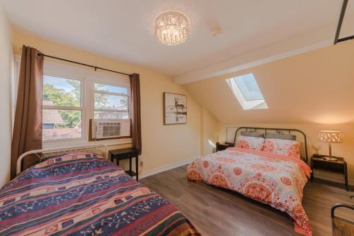 1 dormitorio con 2 camas y ventana en Niagara River&Glenview Home-15MinsWalkToFalls, en Niagara Falls