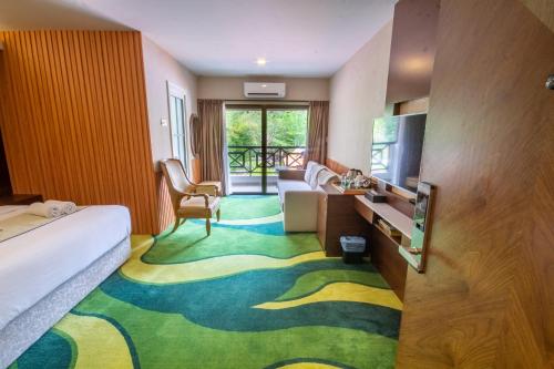 a hotel room with a bed and a television at THE KANDU RESORT in Gopeng