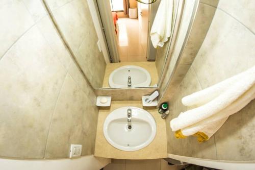 a bathroom with a sink and a mirror at DEPTO CENTRO GODOY CRUZ CON COCHERA in Godoy Cruz