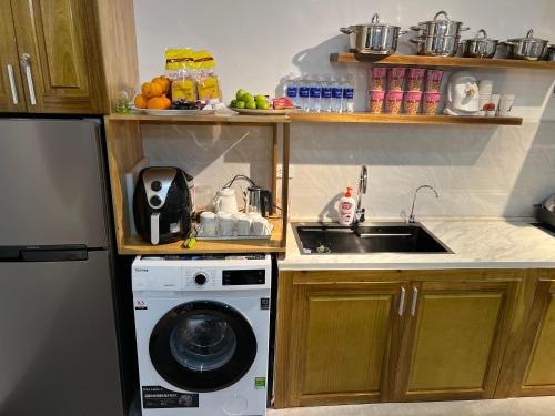 a kitchen with a sink and a washing machine at En nho Homestay SaPa in Sa Pa
