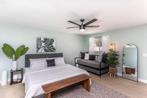 a bedroom with a large bed and a couch at Tropical Playhouse. Heated Pool . Spa . Golf . FUN in Lake Havasu City
