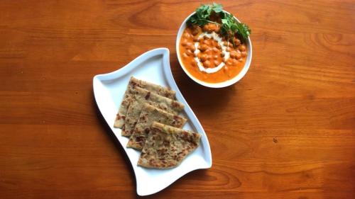 a white plate with three sandwiches and a bowl of soup at Mount Stratus Resort Vayalada in Bālūssheri