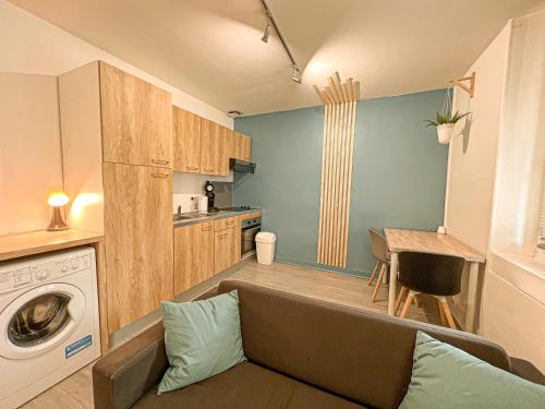 un salon avec un canapé et une machine à laver dans l'établissement LE CLOS CHASSAING N4 -Wifi - Centre ville-PROPERTY RENTAL NM, à Périgueux