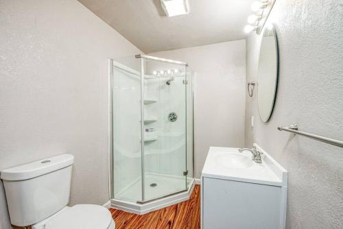 a bathroom with a shower and a toilet and a sink at Stylish Studio 89 Brand New from the floor up in Fresno