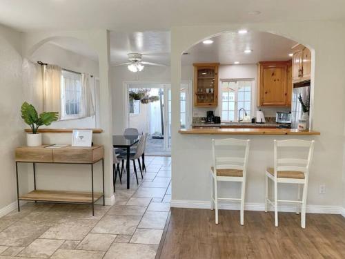 a kitchen and living room with a table and chairs at Hot Tub . Near Freeway . Quick 2 Theme Parks/Beach in Huntington Beach