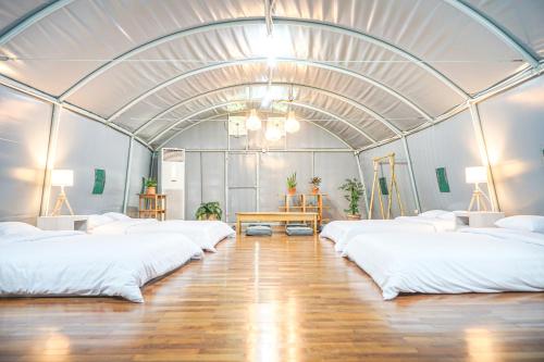 a room with four beds in a domed room at INAGRO in Bogor