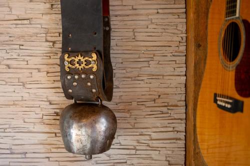 a metal pot hanging on a brick wall at Chalet Bijou in Blitzingen