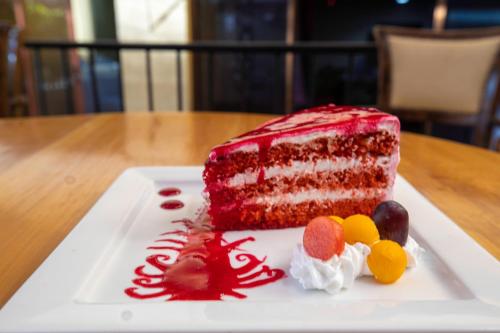 a red velvet cake on a plate on a table at Ngong Hills Hotel in Nairobi