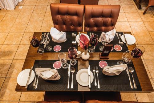 a table with plates and glasses of wine on it at Ngong Hills Hotel in Nairobi