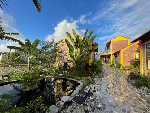 a resort with a stone walkway and some buildings at Ninh Binh Royal Homestay in Ninh Binh