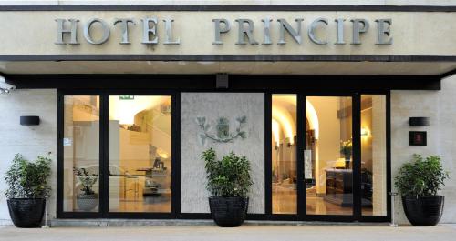 a building with a sign on the front of it at Hotel Principe Di Villafranca in Palermo