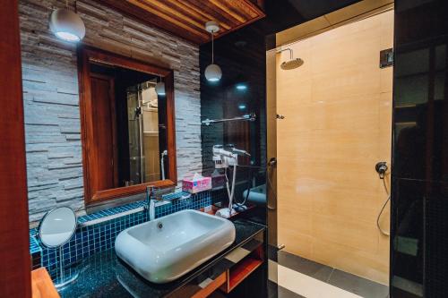 a bathroom with a sink and a toilet at Millennium Island Residence in Fuvahmulah