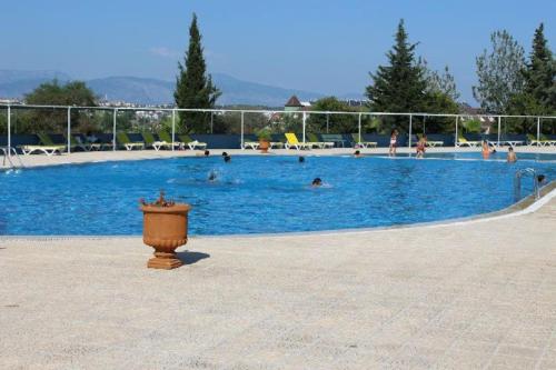 a large swimming pool with people in the water at Summer Villa with pools, beach area, free sun loungers and free car park in Side