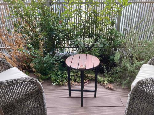 a small table sitting on a patio with two chairs at Dormy Inn Premium Ginza - Natural Hot Spring in Tokyo
