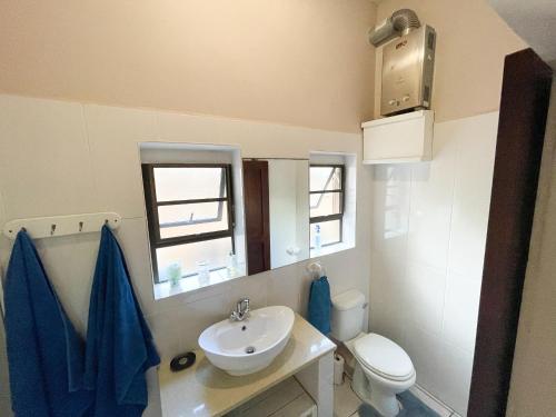 a small bathroom with a sink and a toilet at Kangela 8A in Ponta Malongane