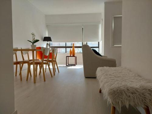 a living room with a table and chairs and a dining room at Aveiro Home in Aveiro